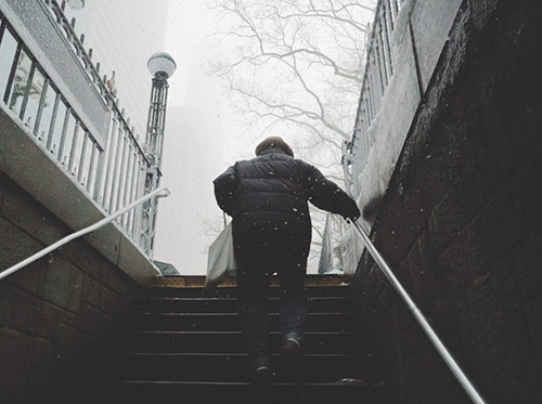 Walking while holding a railing in the snow