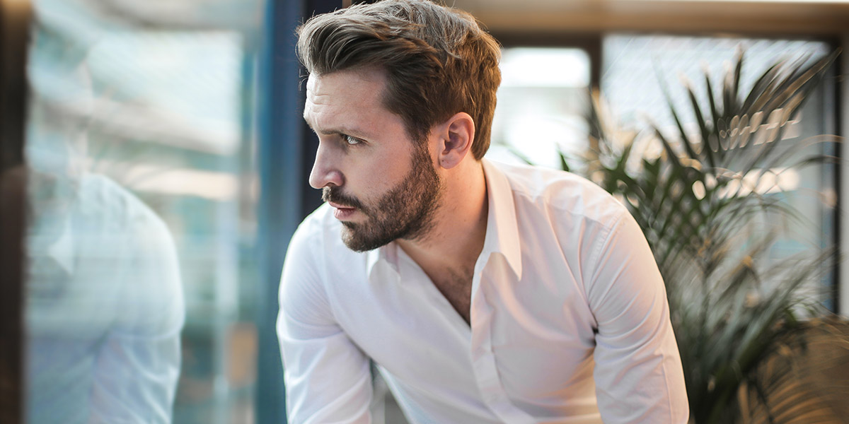 Contemplative Man Staring Out Window Out | Pexels