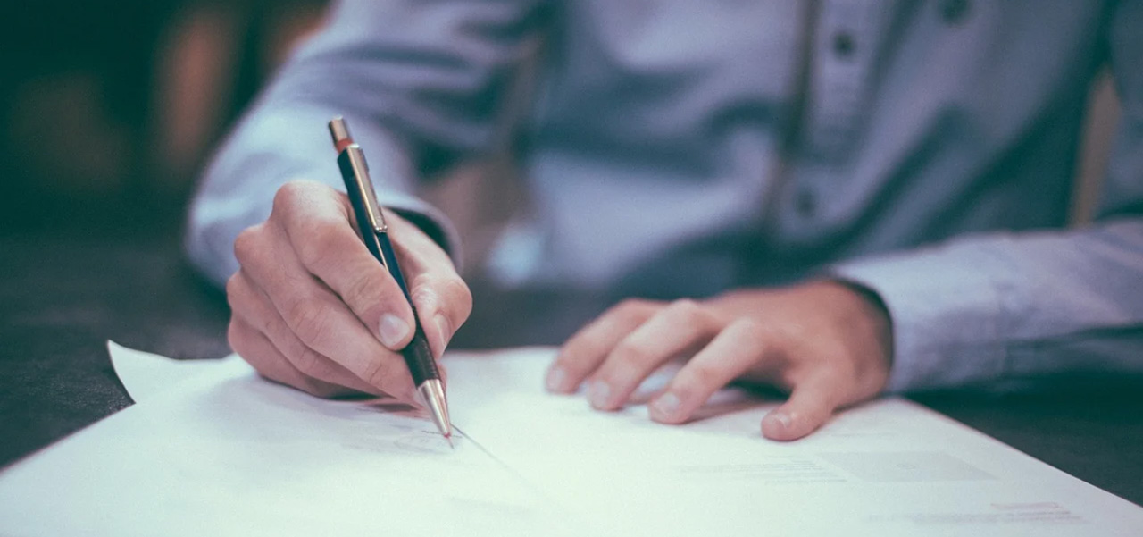 Man filling out health insurance paperwork