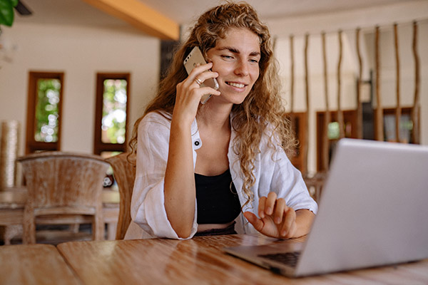 Young woman with curly hair calling her doctor to schedule an appointment