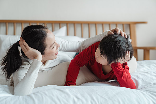 Mother talking to her son; parent talking with their child about wearing a mask