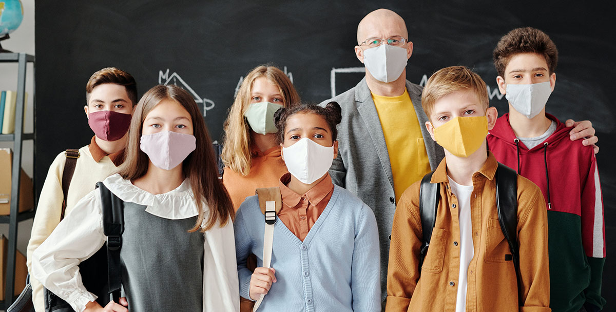 Students and teacher wearing face masks in the classroom