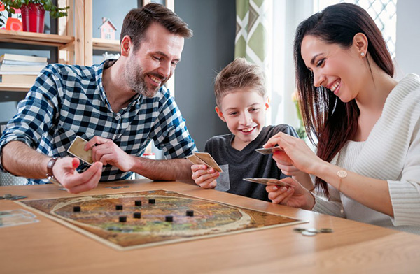 Family game night at home with parents and son