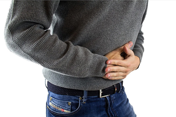 Man suffering from stomach pain, cramps