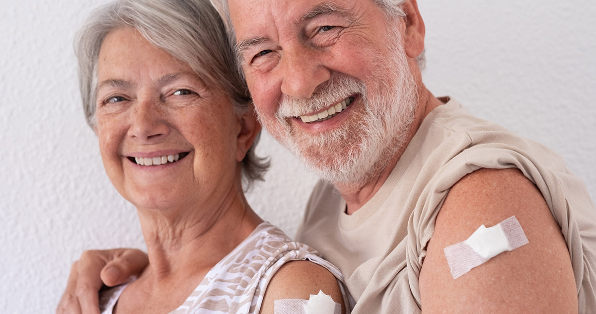 Senior Couple Showing Their Arms with a BandAid Where They Received a Vaccine - Laurel Health explains what to expect when getting your COVID-19 vaccine