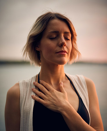 Blond woman breathing deeply easier and enjoying a walk after quitting tobacco | Photo via Unplash