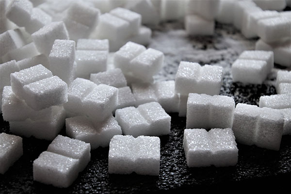 Stacked sugar cubes sitting on a table; photo by Julita on Pixabay (pasja1000)