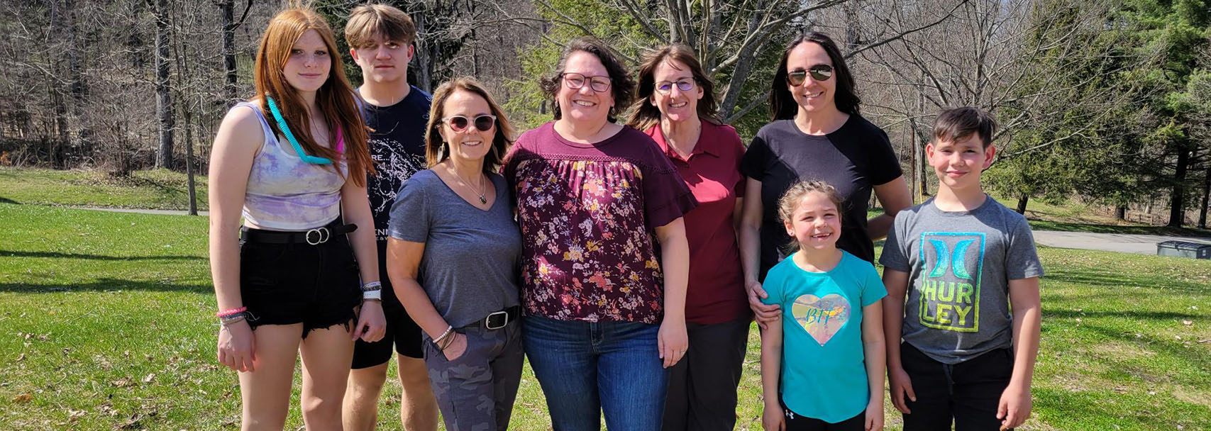 Laurel Health employees and their families enjoying the company Easter event with a colorful outdoor egg hunt, prizes, and snacks