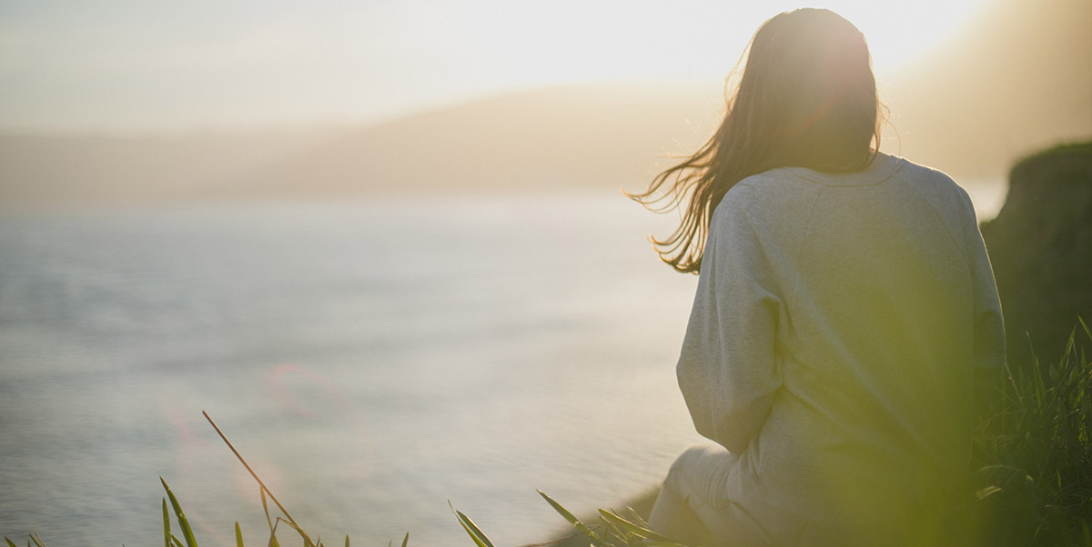 Woman Overlooking Ocean Wellness Banner | Artem-kovalev-unsplash