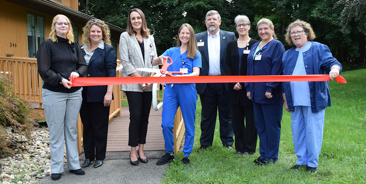 Laurel Health Staff Cut Celebratory Ribbon in front of Laurel Dental - Towanda Dental Clinic During Grand Opening Event