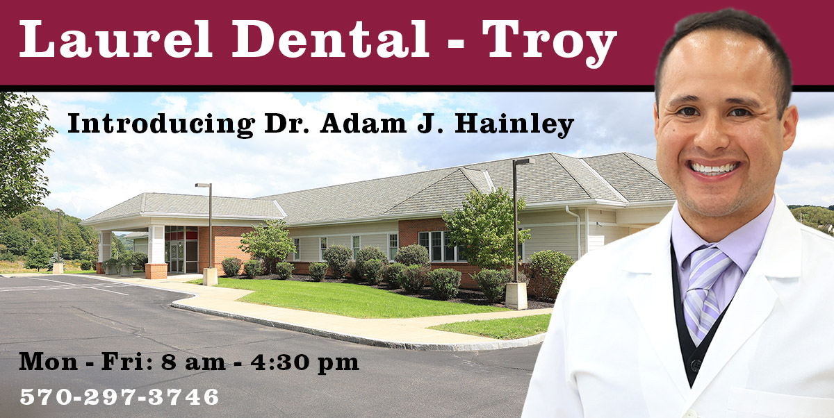 Photo of Dentist Dr. Adam J Hainley, DMD in a white coat, and the Troy Laurel Health Center which now provides family dental / dentistry services at 45 Mud Creek Rd. in Troy, PA