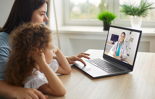 Mother and daughter conduct an online telemedicine visit with female doctor; Laurel Health offers telemedicine and in-person visits at all locations