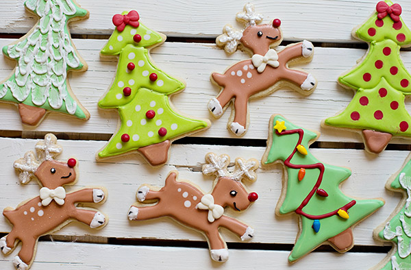 Frosted Christmas Cookies featuring prancing reindeer and decorated christmas trees | Pexels