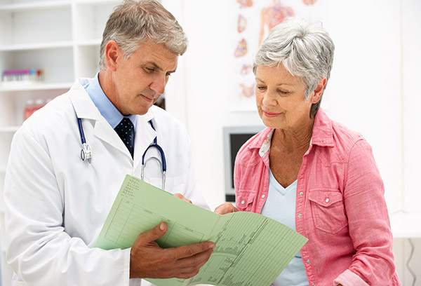 Older female patient reviewing her medical history with her family doctor