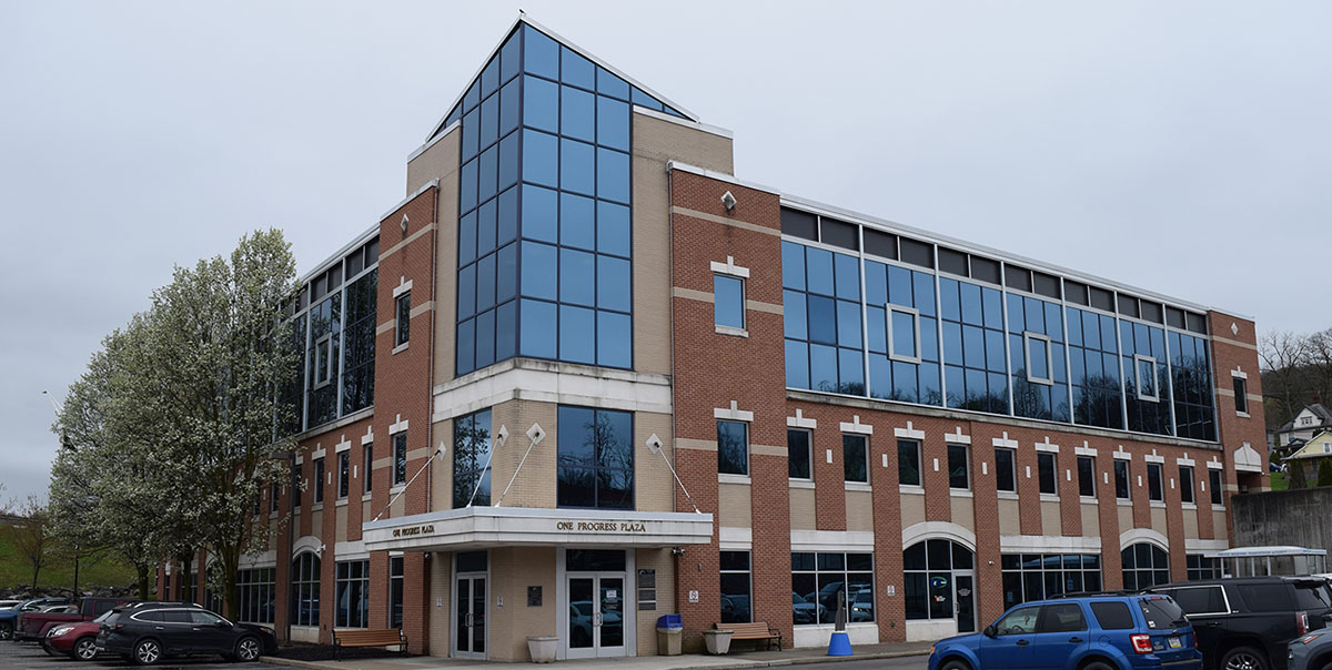 Exterior Photo of the Progress Plaza Building located at 1 Elizabeth St. in Towanda, PA where Laurel Dental is now providing services in Suite 6; it is a large brick building with a marquee entrance and windowed walls