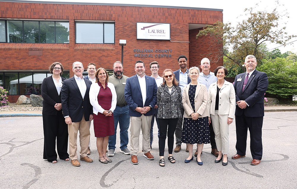 Laurel Health leaders pose with local and state leaders during June's Sullivan County Laurel Health Center celebration.